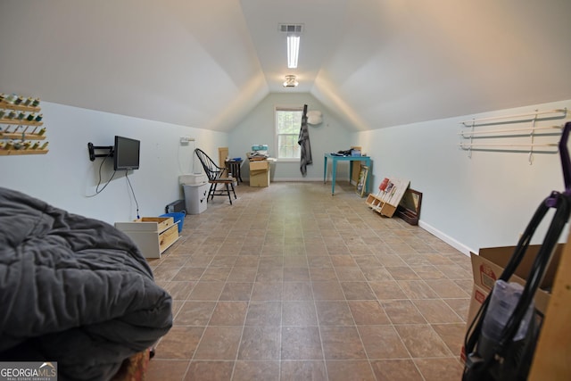 interior space featuring lofted ceiling and visible vents
