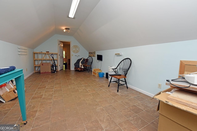 interior space featuring baseboards and lofted ceiling