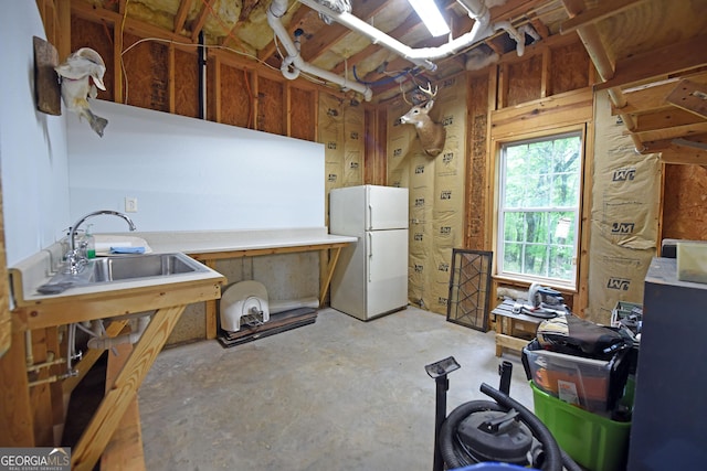 interior space featuring unfinished concrete flooring and a sink