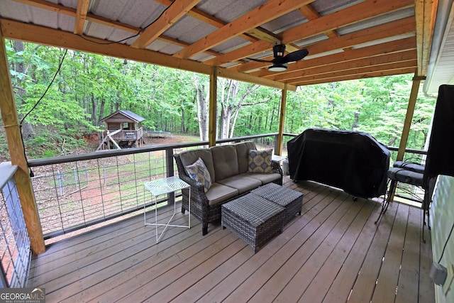 wooden terrace featuring a ceiling fan, an outdoor hangout area, and a grill