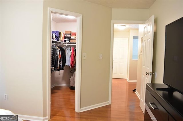 interior space with baseboards and wood finished floors