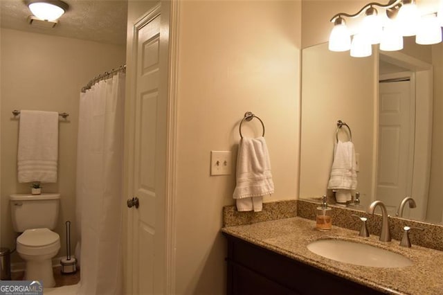 bathroom with toilet and vanity