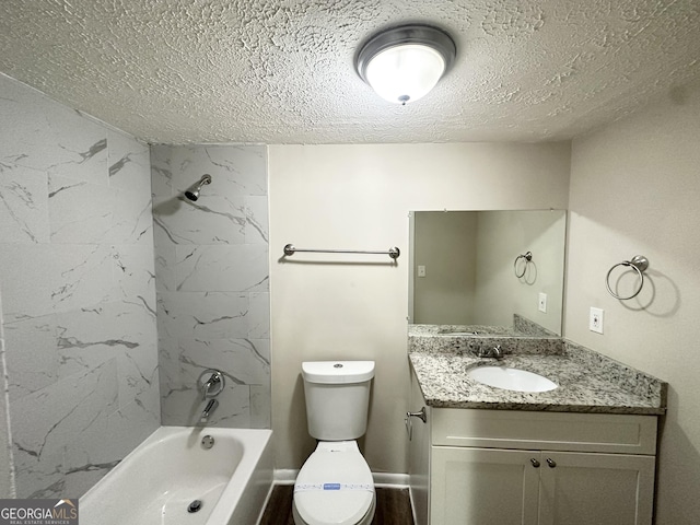 bathroom with vanity, a textured ceiling, washtub / shower combination, and toilet