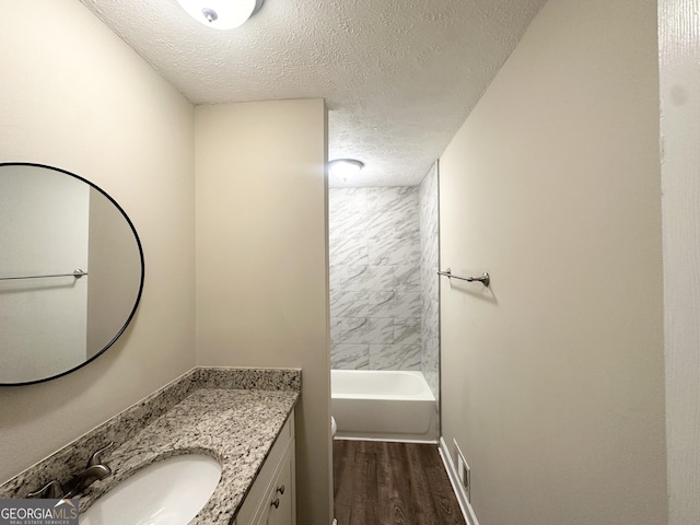 bathroom featuring vanity, a textured ceiling, wood finished floors, and toilet