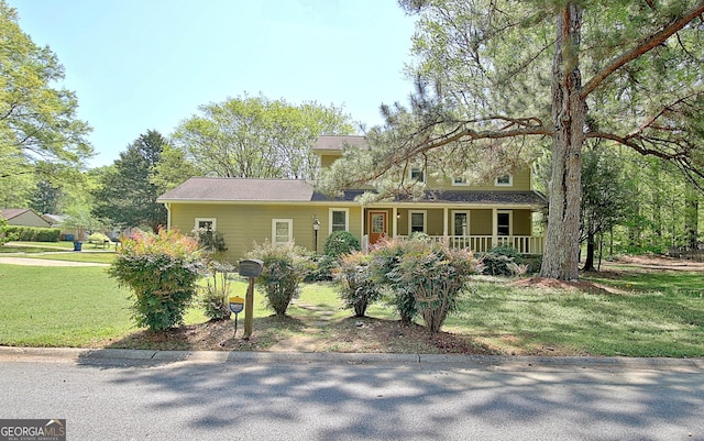 view of front of home with covered porch and a front lawn
