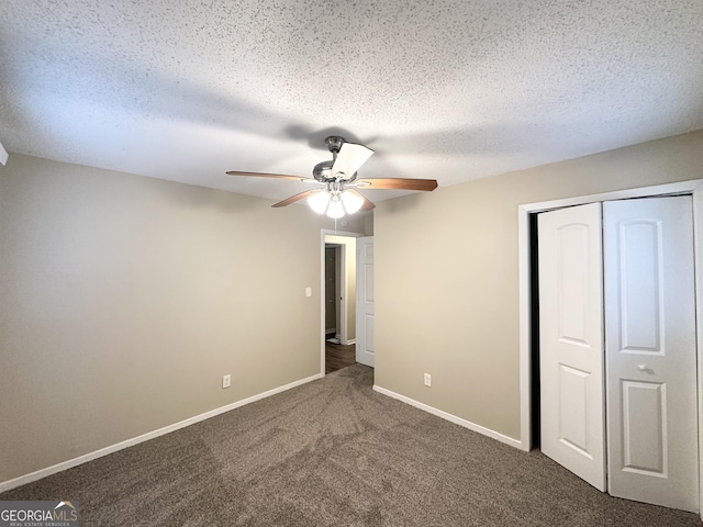 unfurnished bedroom with a closet, a textured ceiling, baseboards, and carpet floors