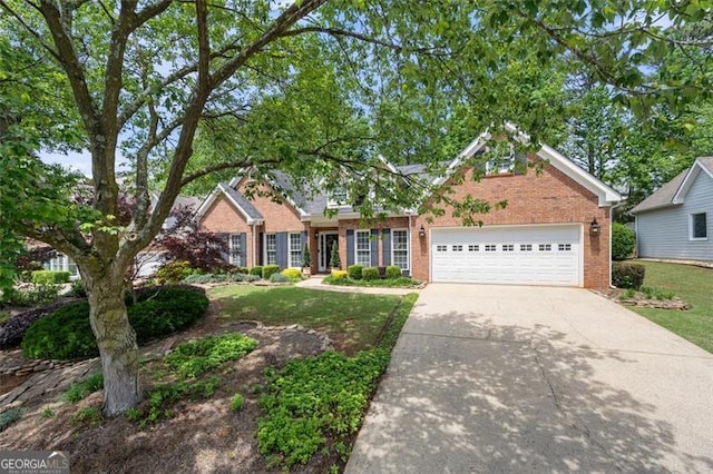 view of front of property featuring brick siding, driveway, a front yard, and a garage