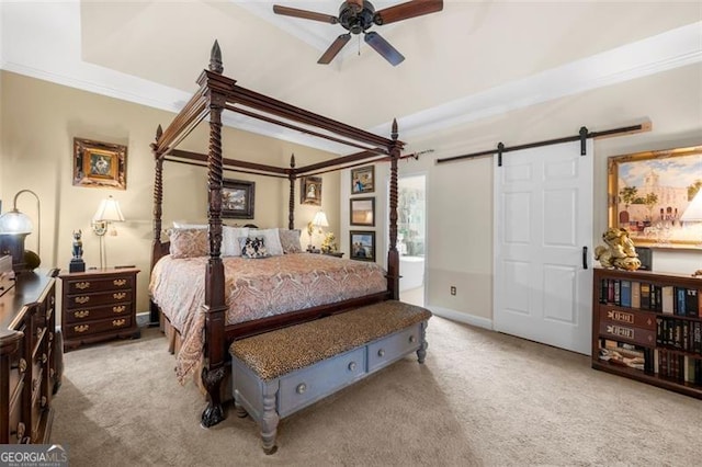 carpeted bedroom with baseboards, a barn door, and ornamental molding