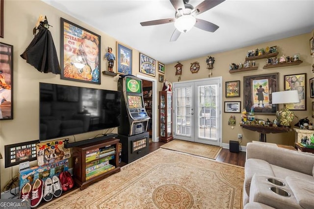 living room featuring baseboards, french doors, ceiling fan, and wood finished floors