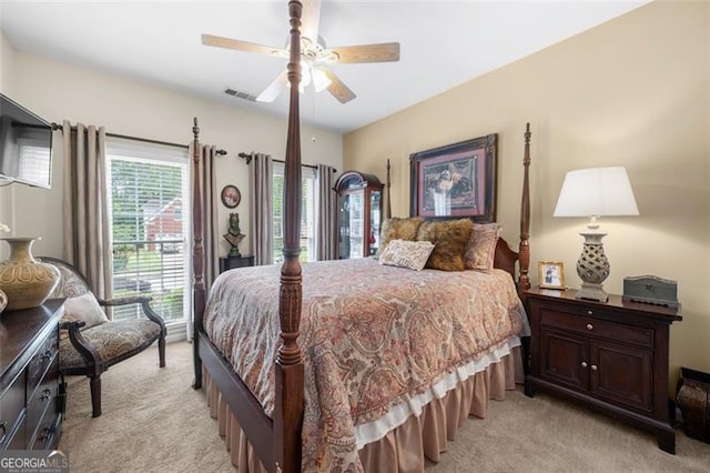 bedroom featuring ceiling fan, visible vents, and light carpet