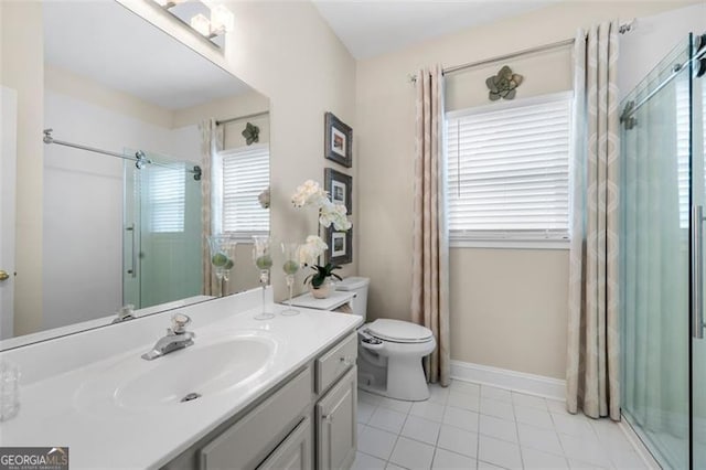 bathroom featuring tile patterned flooring, plenty of natural light, a shower with shower door, and vanity