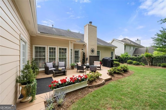 rear view of house with fence, a chimney, an outdoor living space, a patio area, and a yard