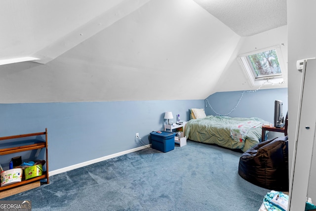 bedroom featuring vaulted ceiling with skylight, carpet floors, baseboards, and a textured ceiling