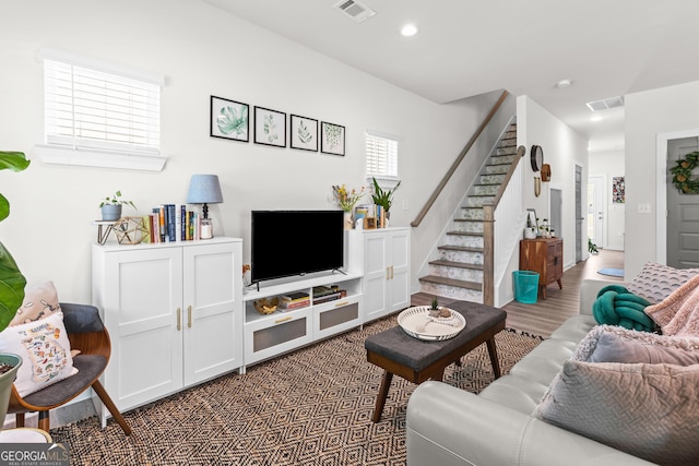 living room with stairway, recessed lighting, and visible vents