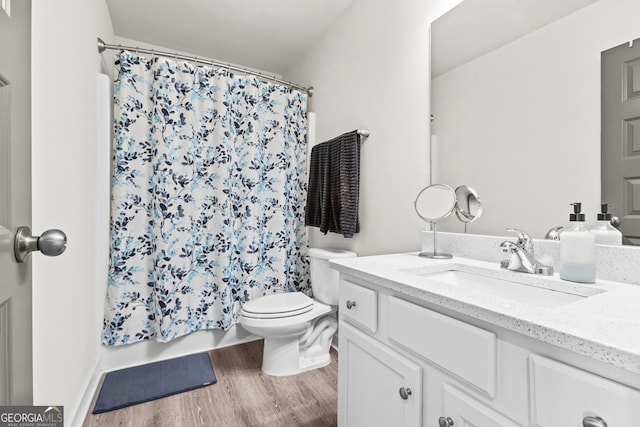 bathroom with vanity, shower / bathtub combination with curtain, toilet, and wood finished floors
