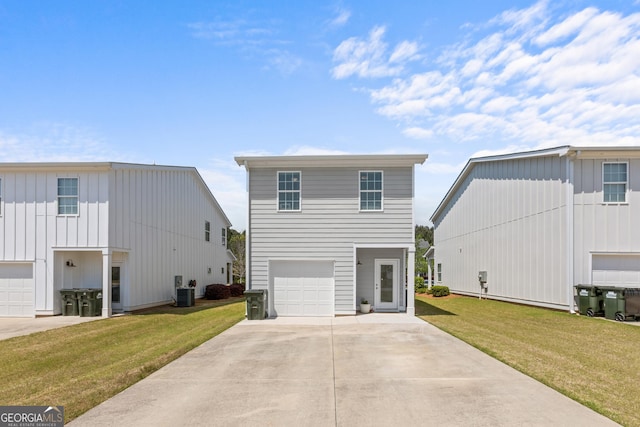 view of front of home featuring concrete driveway, board and batten siding, and a front yard