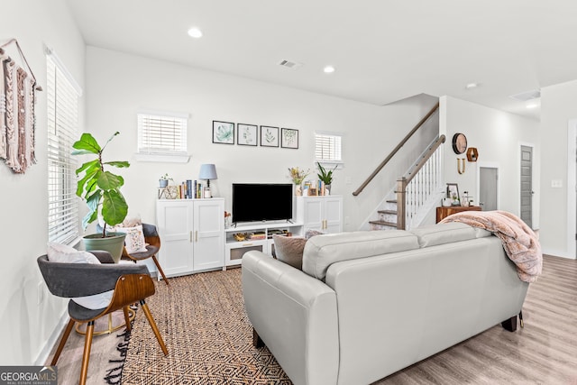 living area featuring visible vents, recessed lighting, stairs, and wood finished floors