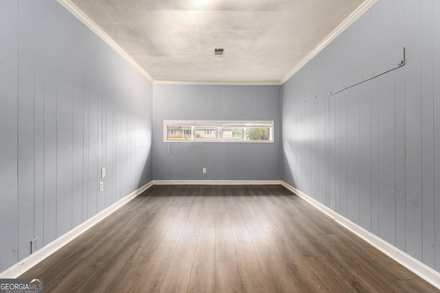 1239 Sharonton Dr, Stone Mountain, GA 30083 - empty room featuring dark wood-style floors, a textured ceiling, crown molding, and wooden walls