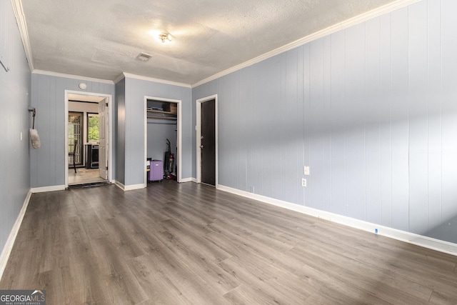 1239 Sharonton Dr, Stone Mountain, GA 30083 - unfurnished living room featuring wood finished floors, ornamental molding, a textured ceiling, and baseboards