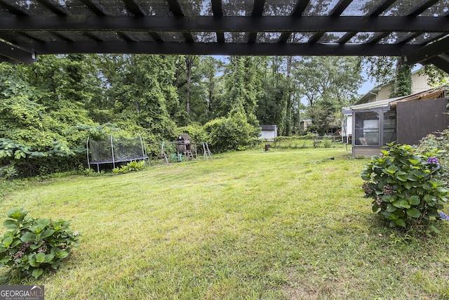 1239 Sharonton Dr, Stone Mountain, GA 30083 - view of grassy yard with a trampoline, a playground, and a pergola