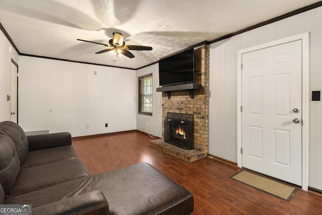 1239 Sharonton Dr, Stone Mountain, GA 30083 - living area featuring a ceiling fan, wood finished floors, ornamental molding, a fireplace, and baseboards