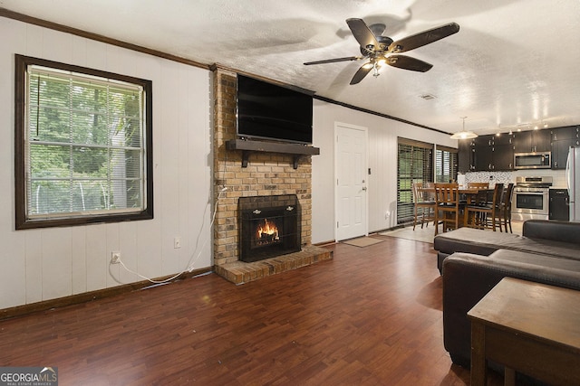 1239 Sharonton Dr, Stone Mountain, GA 30083 - living room with plenty of natural light, wood finished floors, a fireplace, ornamental molding, and a textured ceiling