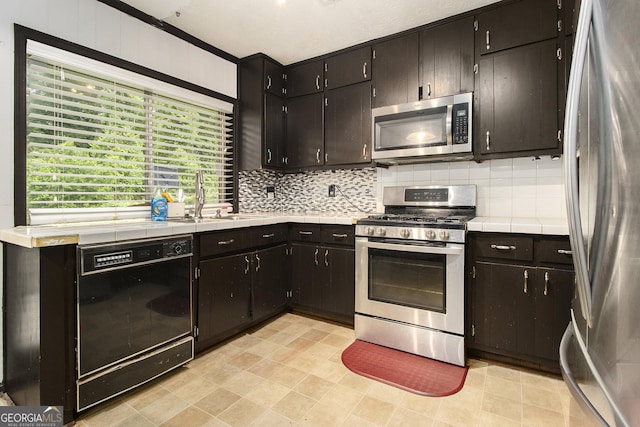 1239 Sharonton Dr, Stone Mountain, GA 30083 - kitchen featuring appliances with stainless steel finishes, a sink, tile counters, and tasteful backsplash