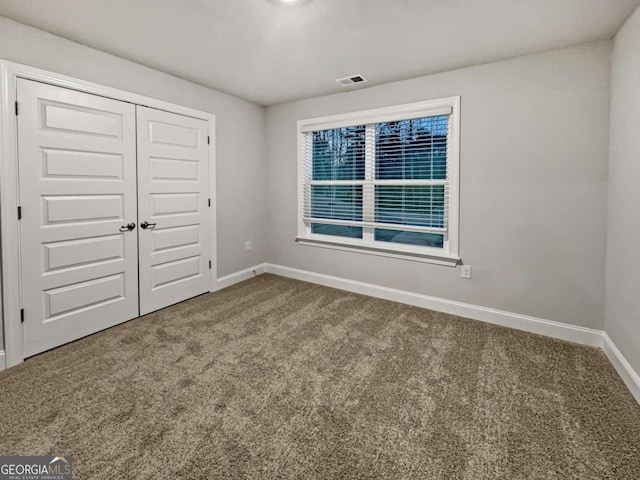 5291 Tuscany Dr, Douglasville, GA 30135 - unfurnished bedroom featuring carpet floors, baseboards, visible vents, and a closet