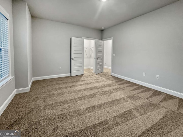 5291 Tuscany Dr, Douglasville, GA 30135 - unfurnished bedroom with carpet floors, baseboards, a closet, and a spacious closet