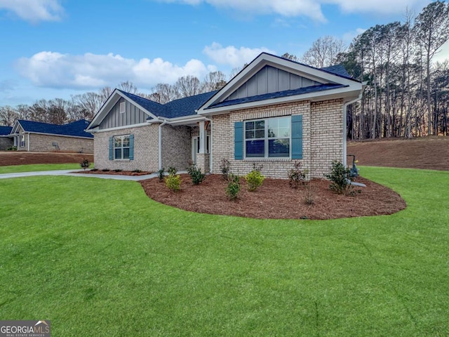 5291 Tuscany Dr, Douglasville, GA 30135 - view of front of property featuring board and batten siding, a front lawn, and brick siding