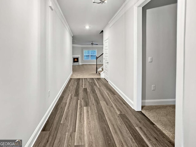 5291 Tuscany Dr, Douglasville, GA 30135 - corridor featuring stairway, baseboards, crown molding, and dark wood-type flooring