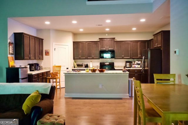 584 Amaranth Trl, Hoschton, GA 30548 - kitchen featuring black appliances, dark brown cabinetry, recessed lighting, and wood finished floors