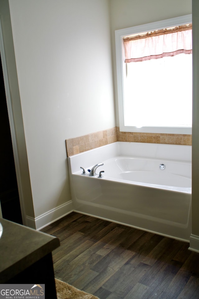 584 Amaranth Trl, Hoschton, GA 30548 - full bath with wood finished floors, a bath, and vanity