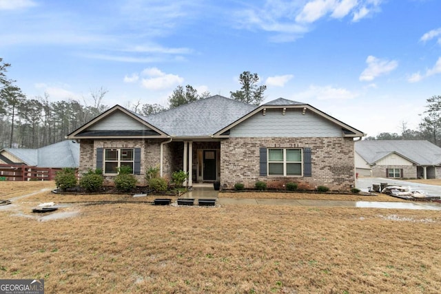 view of front of home featuring brick siding and a front yard