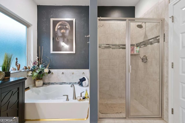 bathroom featuring a garden tub and a shower stall
