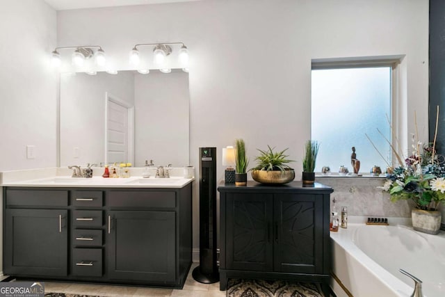 bathroom with double vanity, a sink, and a garden tub