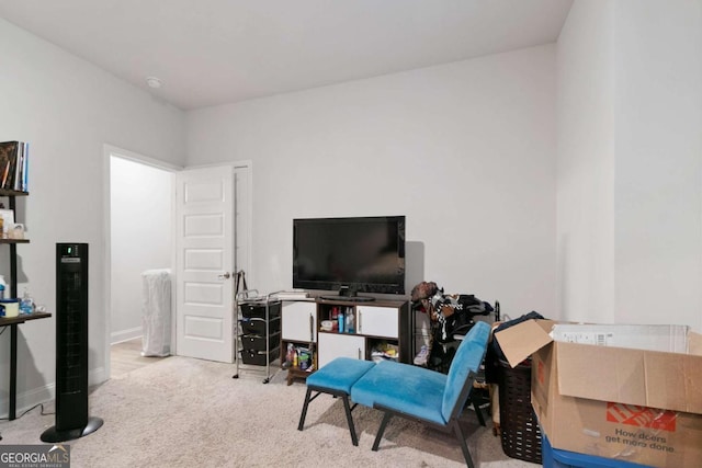 living area featuring carpet