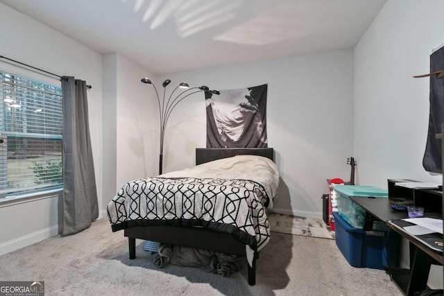 bedroom featuring baseboards, carpet flooring, and multiple windows