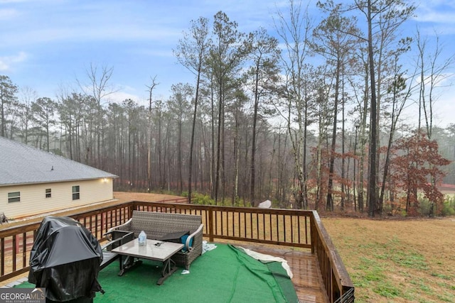 wooden deck with a lawn and a grill