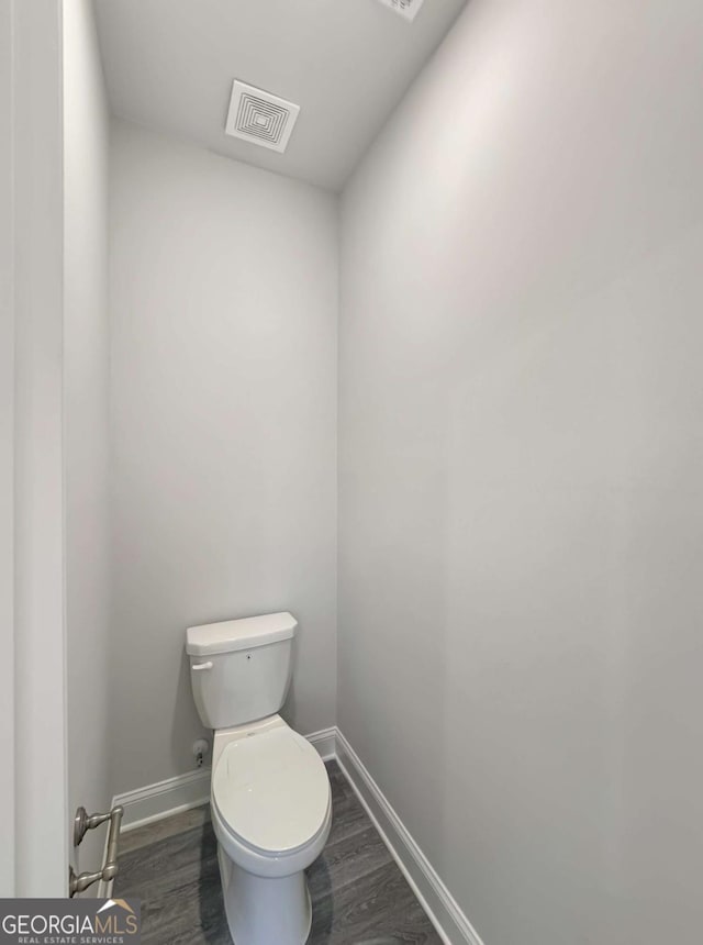 5331 Tuscany Dr, Douglasville, GA 30135 - bathroom with baseboards, toilet, wood finished floors, and visible vents