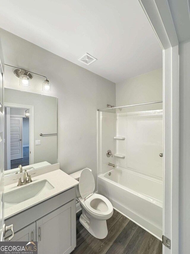 5331 Tuscany Dr, Douglasville, GA 30135 - bathroom with vanity, toilet, shower / bath combination, wood finished floors, and visible vents
