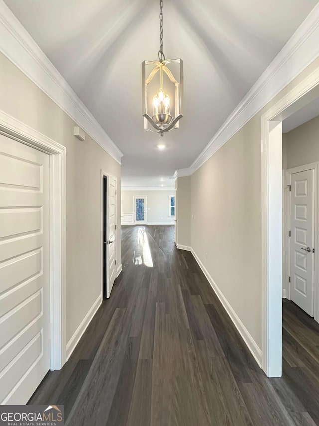5331 Tuscany Dr, Douglasville, GA 30135 - corridor with crown molding, baseboards, a chandelier, and dark wood finished floors