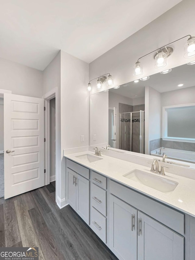 5331 Tuscany Dr, Douglasville, GA 30135 - full bathroom with double vanity, a sink, wood finished floors, and a shower stall