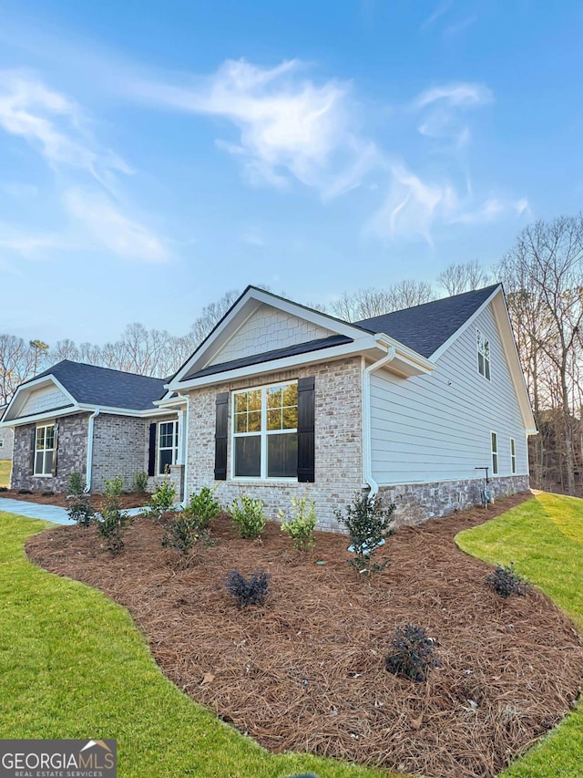 5331 Tuscany Dr, Douglasville, GA 30135 - view of front of property with a shingled roof, a front lawn, and stone siding