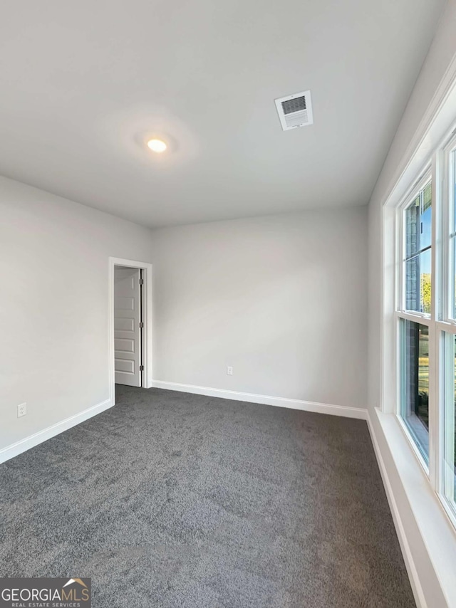 5331 Tuscany Dr, Douglasville, GA 30135 - unfurnished room featuring dark colored carpet, baseboards, and visible vents