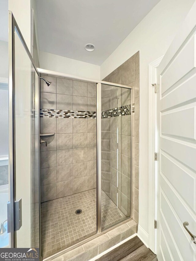 5331 Tuscany Dr, Douglasville, GA 30135 - full bathroom featuring wood finished floors and a shower stall