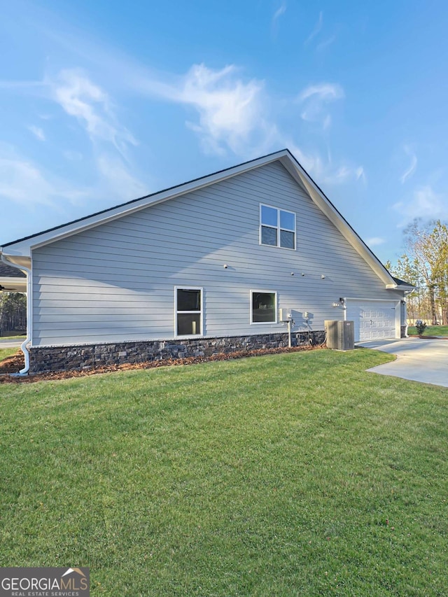 5331 Tuscany Dr, Douglasville, GA 30135 - view of home's exterior with concrete driveway, a yard, central AC, and a garage