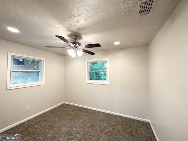 2930 Waters Rd, Atlanta, GA 30354 - unfurnished room with ceiling fan, a textured ceiling, visible vents, baseboards, and dark colored carpet