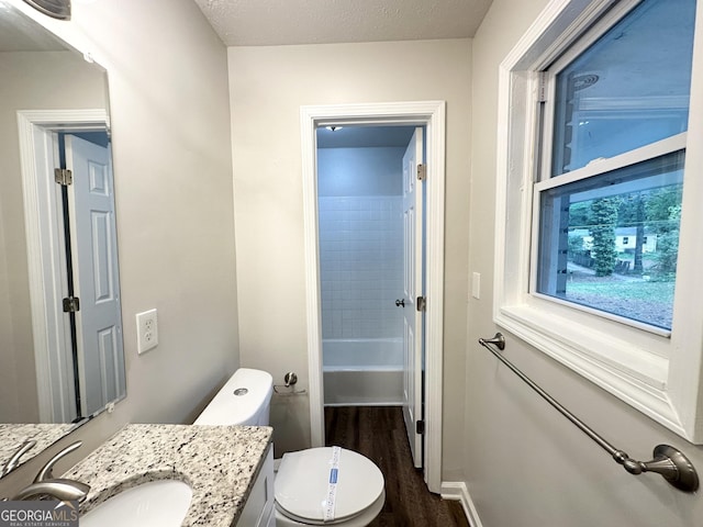 2930 Waters Rd, Atlanta, GA 30354 - bathroom with vanity, wood finished floors, toilet, baseboards, and a bathtub