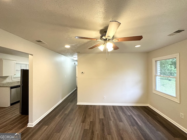 2930 Waters Rd, Atlanta, GA 30354 - unfurnished room featuring dark wood-style flooring, a textured ceiling, visible vents, and a ceiling fan